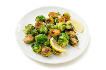 Homemade roasted brussel sprouts with parmesan cheese and butter sauce isolated on white background