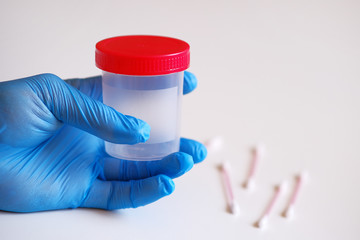 A cotton swab and a sealed jar for testing for coronavirus infection. Rapid testing for coronavirus infection. Prevention of pandemics.