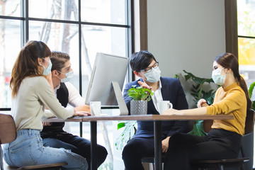 Group of business people with wearing hygienic mask prophylactic manager talking in meeting work...