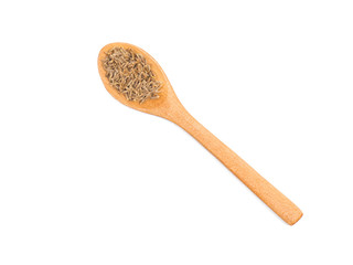 Spice cumin (jeera) in wooden spoon isolated on white