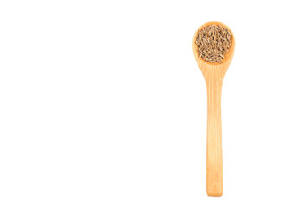 Spice cumin (jeera) in wooden spoon isolated on white