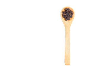 Spice black pepper in wooden spoon isolated on white