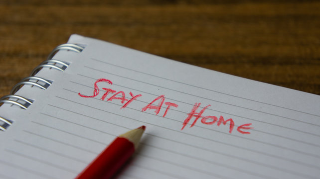 A paper with text Stay at Home. Concept work from home during covid 19 crisis.