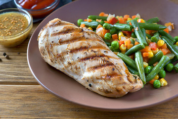 grilled chicken fillet with steamed vegetables and sauce