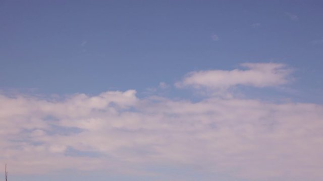4K timelapse light feather clouds floating in the blue sky