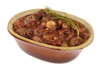 Beef Bourguignon with red wine gravy, mushrooms and shallots in a rustic oven dish isolated on a white background