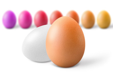 Brown and white eggs against multicolored, isolated on white background