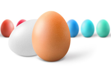 Brown and white eggs against multicolored, isolated on white background