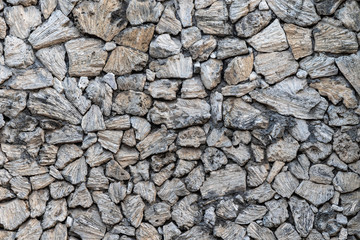 Textured stone wall, built with pieces of native marine sponge. Near Sanur beach, Bali, Indonesia.