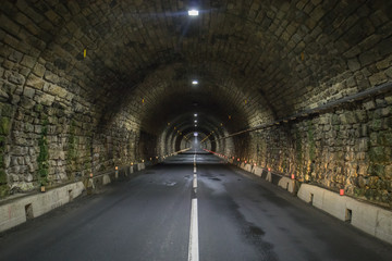 Hochtor tunnel on Grossglockner, at night time, illuminated by lights.