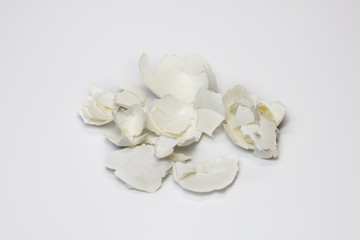 Fototapeta na wymiar Food waste eggshell on a white background. Isolate. Close up. Waste for recycling. Responsible disposal of household food wastage in an environmentally friendly way by recycling.