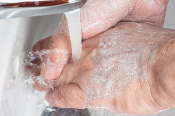 Fototapeta premium A man washing his hands