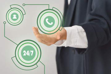 Technical support agent with digital icons on grey background, closeup