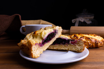 Delicious cheesecake cookie cakes with blueberries and a cup of coffee on a wooden board with copy space