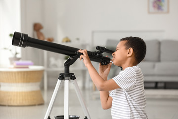 Little African-American boy with telescope at home © Pixel-Shot