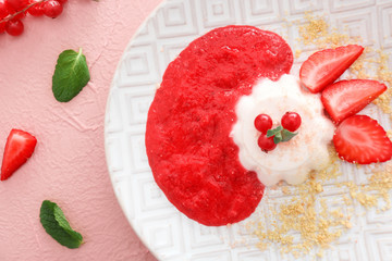 Plate with tasty panna cotta on color background