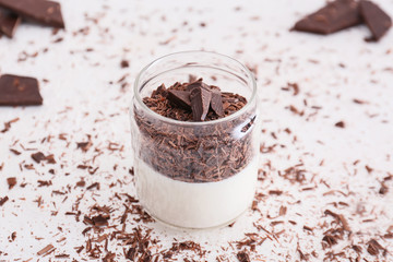 Glass with tasty panna cotta on white background