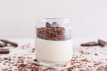 Glass with tasty panna cotta on white background