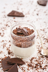 Glass with tasty panna cotta on white background