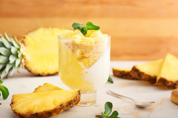 Glass with tasty panna cotta on table