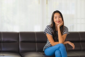 Obraz premium Portrait beautiful young asian woman happy smile relax on sofa in living room