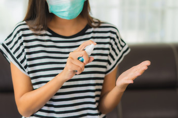 Portrait beautiful young asian woman use alcohol spray for clean her hand from coronavirus or covid19