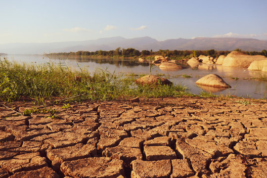 Dry cracked earth background in arid season. Many Province of North East in Thailand the ground dry. Brown cracked soil in the summer When water in Mekong dry up.
