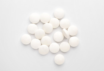 Heap of pills on white background