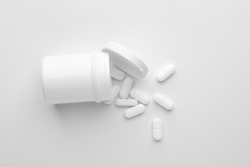 Jar with pills on white background