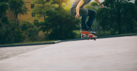 Skateboarder legs skateboarding on morning outside parking lot