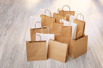 Many paper shopping bags on floor