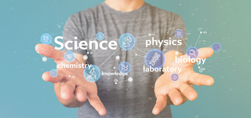 Businessman holding Science icons and title