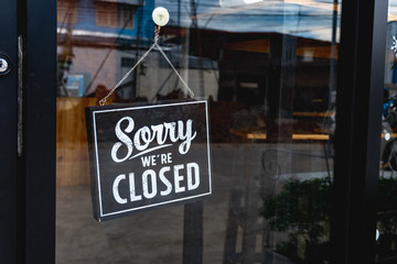 "Sorry we're closed" message board on a window