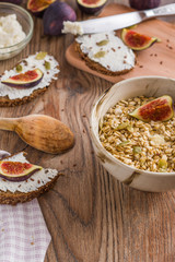 oatmeal with butter seeds and figs on a wooden table