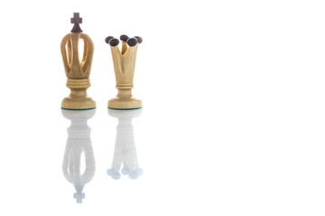 A view of king and queen white chess pieces. Wooden chess pieces against white color background