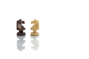 A view of knights chess pieces. Wooden chess pieces against white color background
