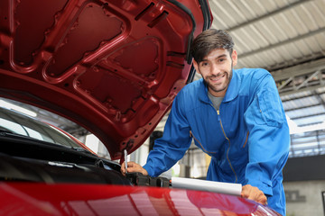 Auto mechanic checking problem for the car engine at the garage,technician or engineer professional work for customer