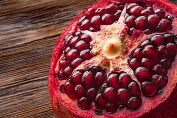 Peeled pomegranate on the wooden table