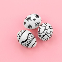 Easter eggs are painted black and white, abstraction, are nearby. 