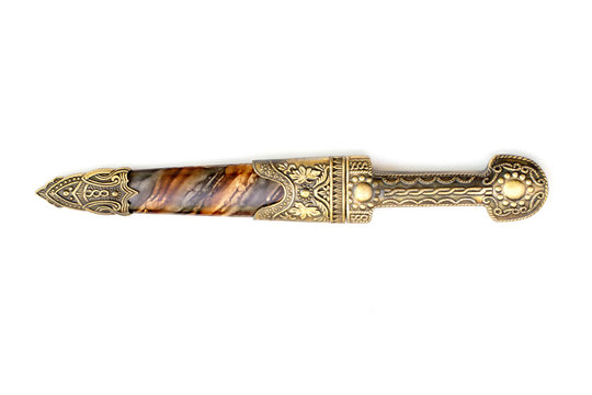 Ornate ceremonial dagger next to a jeweled scabbard