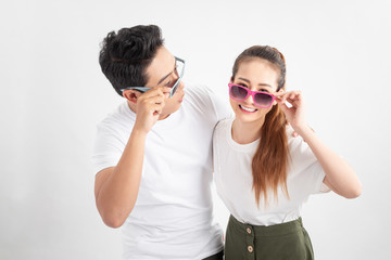 Young cheerful couple in love with glasses huging each other