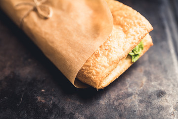 Freshly cooked sandwiches with roasted chicken, tomatoes and salad leaves. Selective focus. Shallow depth of field.
