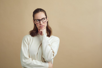 Portrait of mad woman thinking and looking to the side 