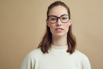 Portrait of beautiful and serious woman looking into the camera