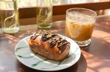 Cocoa bread topped with almonds on a wooden table