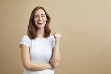 Portrait of happy smiling girl on a modern color background