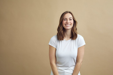Portrait of happy smiling girl on a modern color background