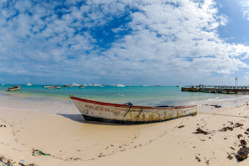Fototapeta na wymiar Beautiful old boat and sand beach in Punta Cana, Dominican Republic