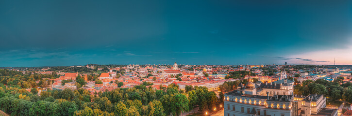 Naklejka na ściany i meble Vilnius, Lithuania, Eastern Europe. Historic Center Cityscape In Blue Hour After Sunset. Travel Panorama Of Old Town In Night Illuminations. UNESCO. Palace Of Grand Dukes Of Lithuania.