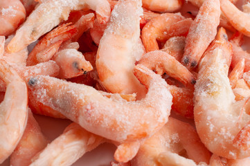Frozen king prawns on a white plate